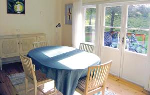 a dining room with a blue table and chairs at Holiday Home Braås Herrgård Braås in Braås