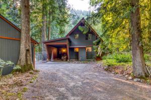 a house in the woods with a driveway at Rustling Waters Getaway in Rhododendron