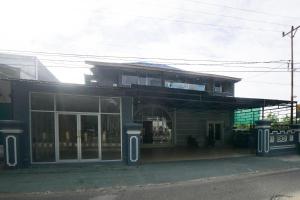 ein Geschäft vor einem Gebäude mit Glasfenstern in der Unterkunft RedDoorz Syariah near RSUD Ainun Habibie Gorontalo in Limboto