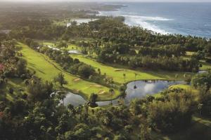 an aerial view of a golf course next to the ocean at Villa Iris 2 story ocean view villa w/ pool access in Vega Alta