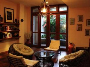 a living room with chairs and a table and a window at Lafala Hotel & Service Apartment in Colombo