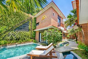 an apartment with a swimming pool in front of a building at MAI Villa Da Nang in Da Nang