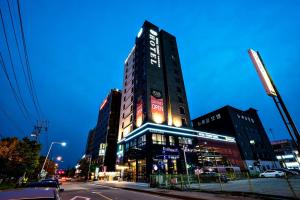 a tall building on a city street at night at Siheung Seoul Tourist Hotel in Siheung