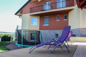 a pair of purple chairs sitting on a patio at Synergy House in Dudince
