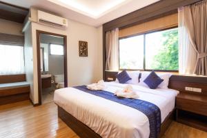 Una cama o camas en una habitación de Lima Lanna Hotel