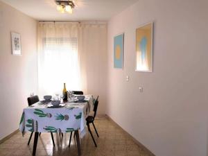 a dining room with a table with chairs and a window at 1Bdrm APT With Panoramic View of Sea and Mountains in Tiberias
