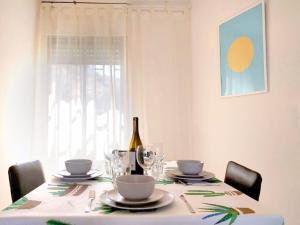 a dining room table with a bottle of wine on it at 1Bdrm APT With Panoramic View of Sea and Mountains in Tiberias