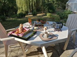 a white table with a tray of food on it at Chez Cyril et Vi in Saint-Règle