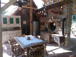 a kitchen with a table and a stone wall at 200 éves vendégház in Balatonalmádi