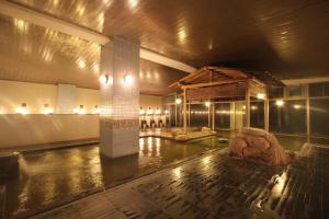 a room with a column in the middle of a building at Hotel Towadaso in Towada