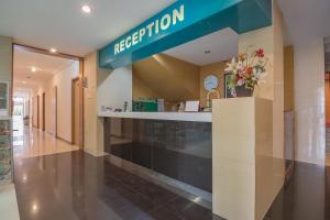 a reception area of a hospital with a sign on the wall at RedDoorz At Hotel Arimbi Dewi Sartika Baru in Bandung