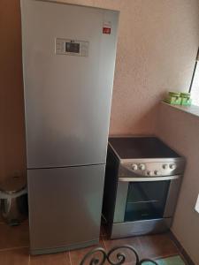 a small stove and a refrigerator in a kitchen at VASILIJA, studio apartman in Budva