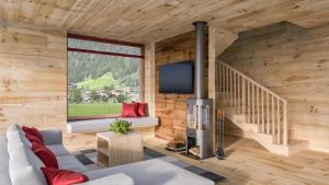 a living room with wooden walls and a large window at HOCHoben Chalets & Mobilhomes in Mallnitz