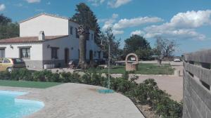 a house with a fountain in front of it at Mas del Tancat in Amposta