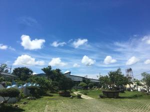 a park with trees and a water tower in the background at Kenting Yeh Zhan in Hengchun