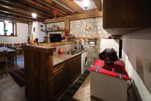 a kitchen with a sink and a stove top oven at Тодорината къща in Leshten