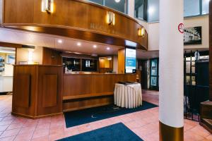 a lobby with a hotel counter with a suitcase at Comfort Guesthouse in Pietarsaari