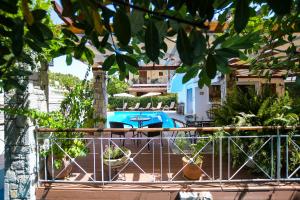 a view from the balcony of a house with a swimming pool at Neda Hotel in Olympia