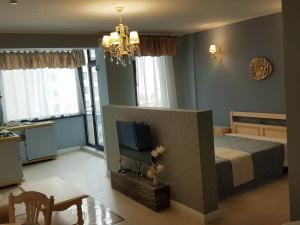 a bedroom with a bed and a flat screen tv at Luxury Studio Anis 1 in Mamaia Sat/Năvodari