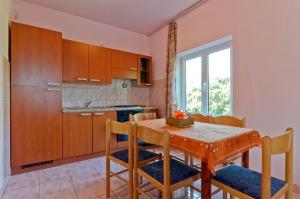 a kitchen and dining room with a table and chairs at Apartments Jerković in Stari Grad
