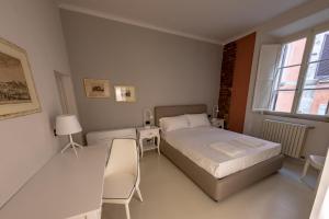 a bedroom with a bed and a table and chairs at Toselli new suite in Pisa
