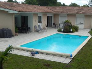 a swimming pool in the yard of a house at Villa De Guénifey in Josse