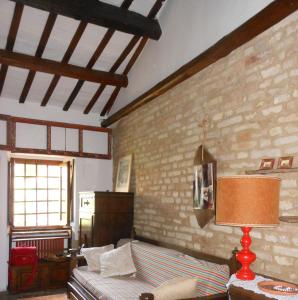 a bedroom with a bed and a brick wall at Casa Elena sul mare a Torre di Palme in Marina Palmense