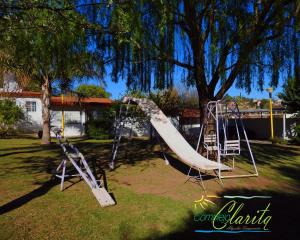 a playground with a slide in a park at Complejo Clarita in Villa Carlos Paz