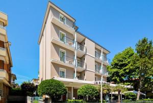 a large building with balconies on the side of it at Hotel Firenze in Bellaria-Igea Marina