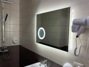 a bathroom with a blow dryer and a mirror at Hotel Lahuta in Kolgecaj