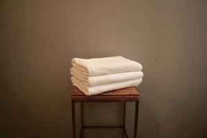 a pile of towels sitting on top of a table at Book And Bed Tokyo Shinjuku in Tokyo +24 photos