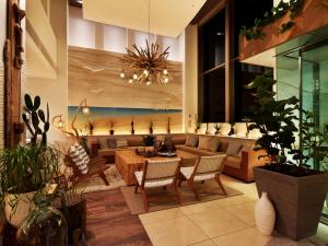 a living room with a couch and a table and chairs at Hayama Umino Hotel in Hayama