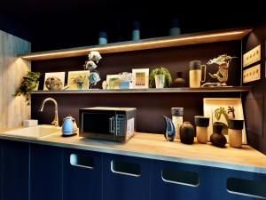 a kitchen counter with a microwave and a sink at Hayama Umino Hotel in Hayama