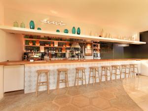 a bar with bar stools in a restaurant at Hayama Umino Hotel in Hayama