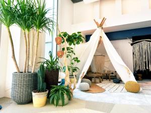 a room with potted plants and a tent at Hayama Umino Hotel in Hayama
