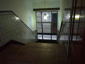 a room with a door and a staircase with a light at Bernardo López con opción a parking in Jaén