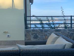 a room with a couch and a view of the ocean at San Giorgio La Litoranea in La Spezia