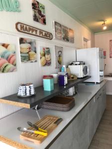 a kitchen with a counter with a happyride sign on the wall at Le 81 HOTEL in Castres