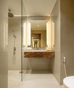 a bathroom with a sink and a shower at Hotel Santika Gresik in Gresik