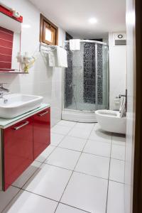 a white bathroom with a sink and a shower at Bagoz Hotel in Istanbul