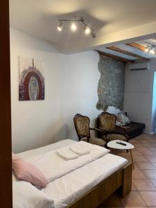 a bedroom with a bed and two chairs at Apartment ILI in Piran