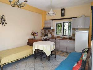 a kitchen with a table and a table and a room at Paradise City studios in Loutraki