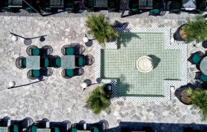 an overhead view of a patio with a table and chairs at Katikies Garden Santorini - The Leading Hotels Of The World in Fira