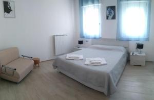 a bedroom with a bed and a chair in it at B&B Oleum in Terlizzi