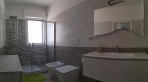 a bathroom with a toilet and a sink and a mirror at B&B Oleum in Terlizzi +17 photos