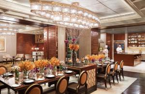 a dining room with a long table and chairs at Four Seasons Hotel Mumbai in Mumbai