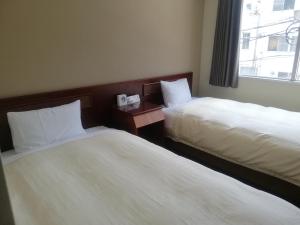 Säng eller sängar i ett rum på Hotel Tokuyama Hills Heiwadoriten