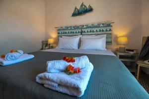 a bedroom with a bed with towels on it at Aglaia V Studio in Gaios +3 photos