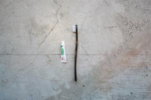 a toothbrush and a tube of tooth paste on a table at Book And Bed Tokyo Shinjuku in Tokyo