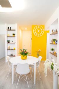 a dining room with a white table and white chairs at Your home in Letojanni in Letojanni